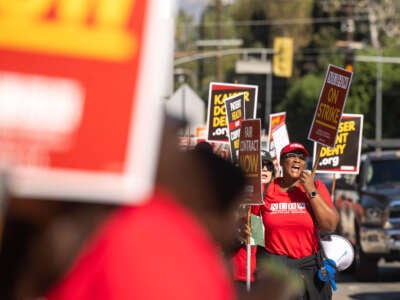 Psychiatric social worker Danielle Jones leads chants as mental health workers walk the picket line at Kaiser Permanente in Woodland Hills in Los Angeles, California, during the second day of a strike on October 22, 2024.